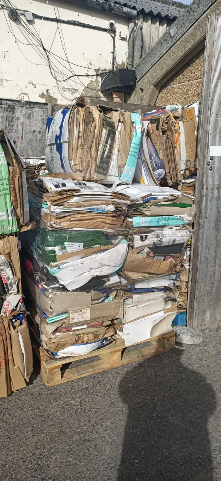 How cardboard is recycled — palletised cardboard bales loaded for transport to recycling